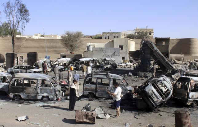 Burnt-out vehicles are seen at a gas station after it was hit by an air strike in Yemen's northwestern city of Saada