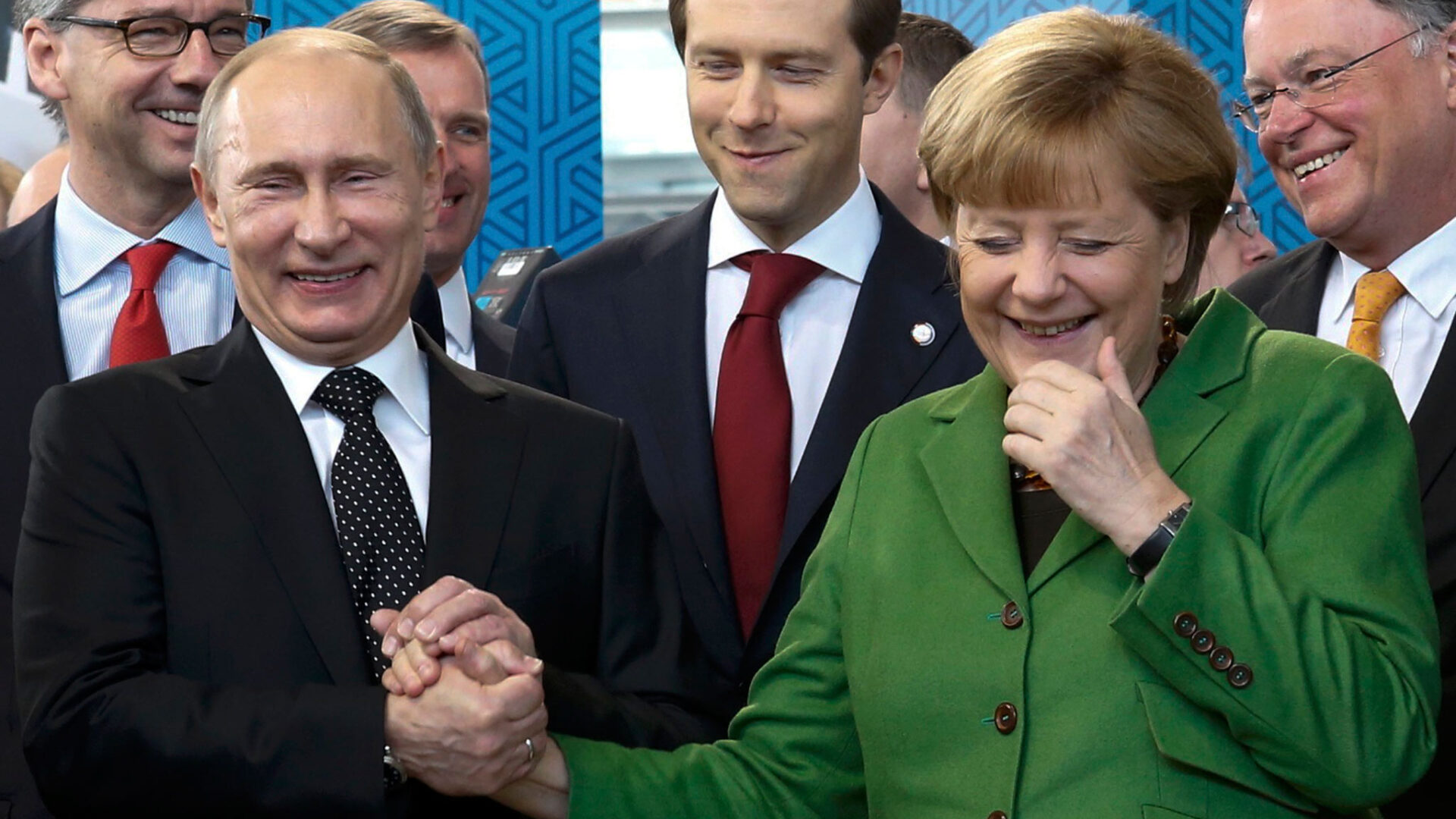 Russian President Putin holds hand of German Chancellor Merkel during tour of Hanover Messe in Hanover
