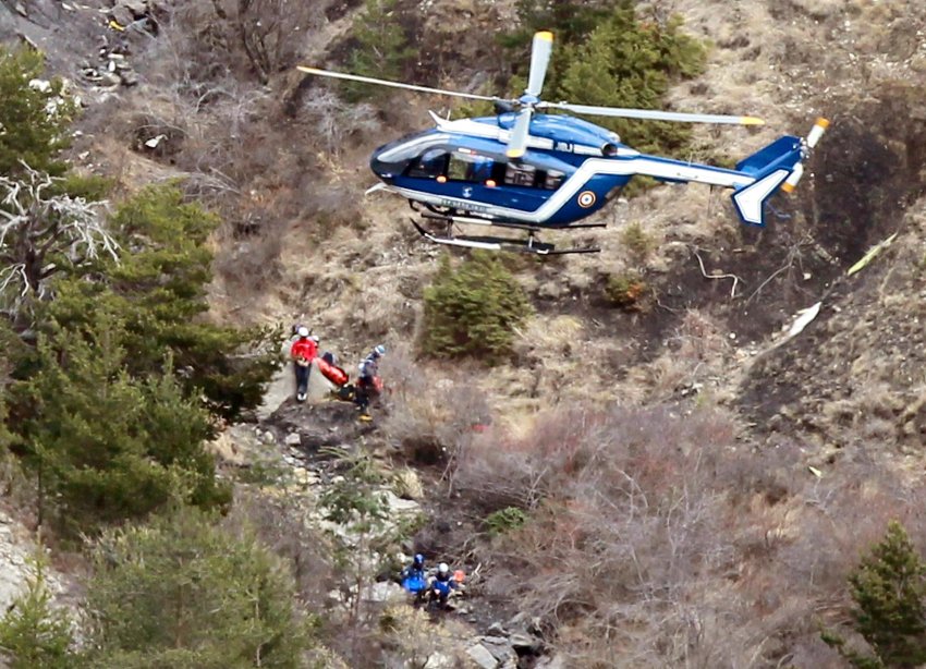 A French gendarme helicopter flies over the crash site of an Airbus A320, near Seyne-les-Alpes